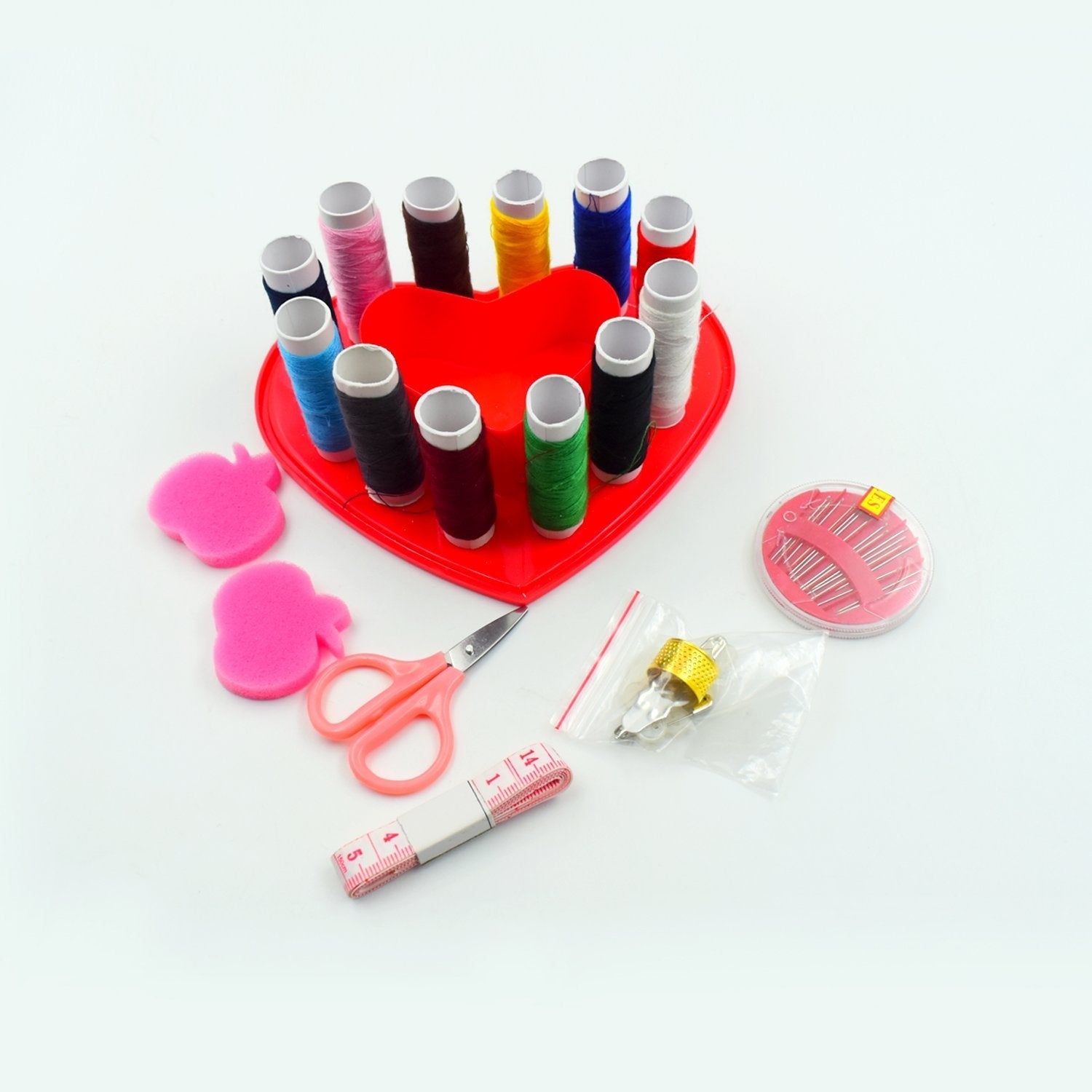 Compact heart-shaped sewing box with various sections